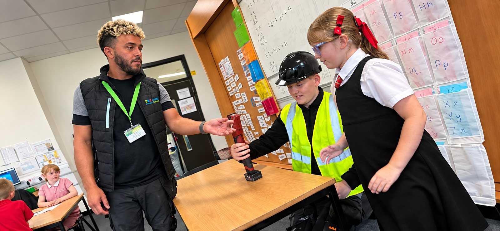 Pupils taking part in a hands-on tool demonstration led by an Energy Made Greener engineer